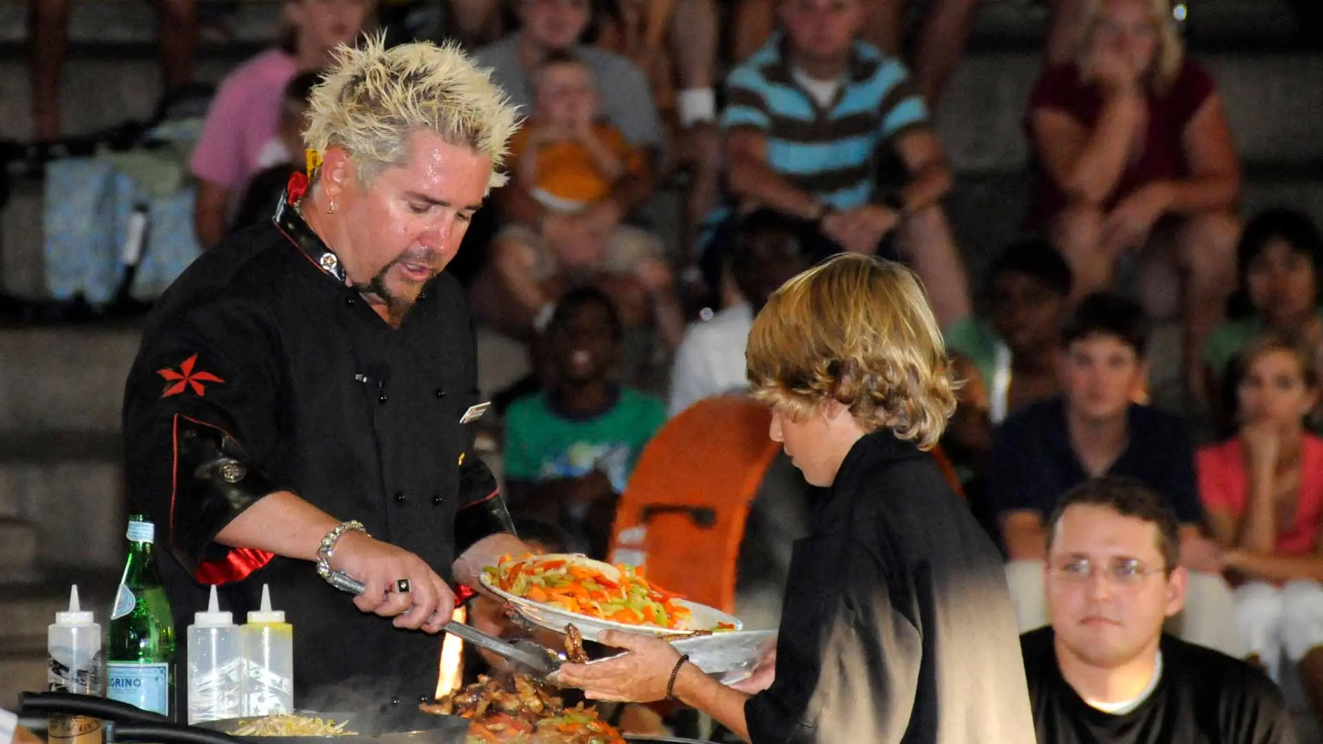 Guy Fieri and his son perform a cooking demonstration for more than 500 U.S. Sailors and their families
