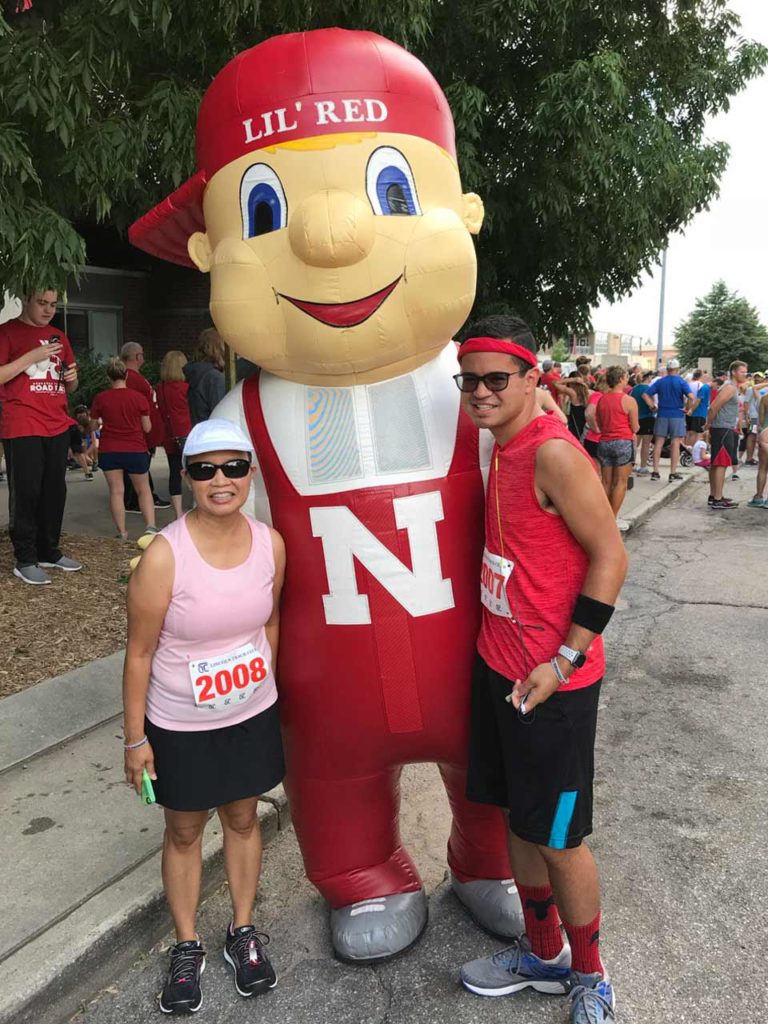 The late Lil Gibson poses with son Justin and Cornhusker mascot Li’l Red at the Nebraska Football Road Race