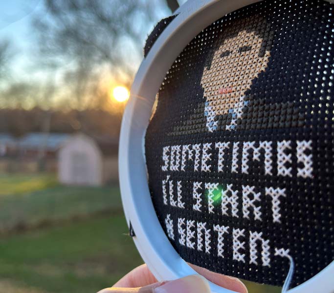 Cross stitch design of Michael Scott from “The Office” with quote trailing off: “Sometimes I’ll start a senten-”